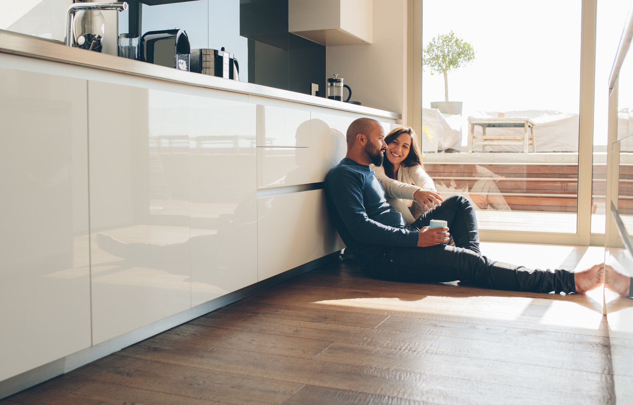 Couple sitting on kitchen floor
